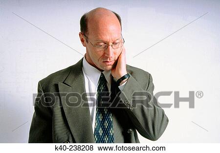 Man, 40-45, in suit, with concerned look on face View Large Photo Image Stock Photo - Man, 40-45, in suit, with concerned look on face. Fotosearch