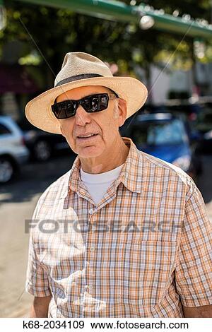 man, 58, wearing a panama hat and sunglasses. View Large Photo Image Stock Photo - man, 58, wearing a panama hat and sunglasses.. Fotosearch