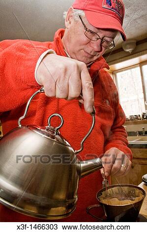 Man 62 pouring water from tea kettle to make coffee Cable Wisconsin WI USA View Large Photo Image Stock Image - Man 62 pouring water from tea kettle to make coffee Cable Wisconsin WI USA. Fotosearch