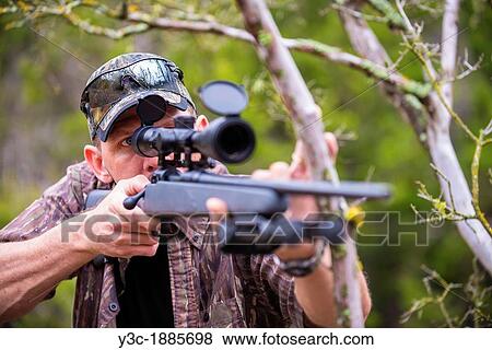 Man about to shoot a hunting rifle, 40 years old, Caucasian, Texas, USA View Large Photo Image Stock Photo - Man about to shoot a hunting rifle, 40 years old, Caucasian, Texas, USA. Fotosearch