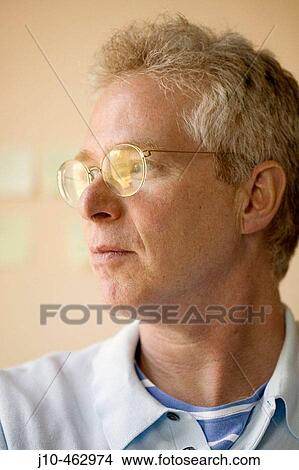 Man age 53, looking out window, Cambridge, Massachusetts. USA. View Large Photo Image Picture - Man age 53, looking out window, Cambridge, Massachusetts. USA.. Fotosearch