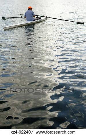 Stock Photo - man alone in rowing skull. Fotosearch