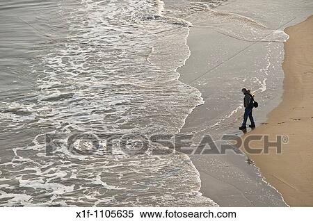 Man alone on south beach Tenby, Pembrokeshire, Wales, UK View Large Photo Image Stock Photography - Man alone on south beach Tenby, Pembrokeshire, Wales, UK. Fotosearch