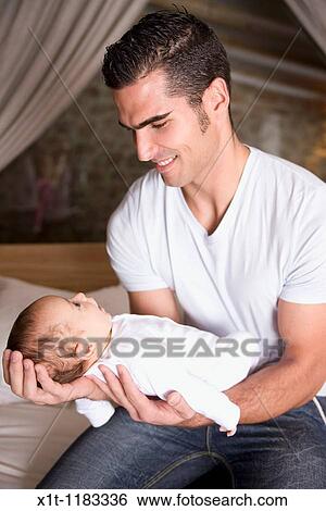 Stock Photograph - Man and baby.. Fotosearch