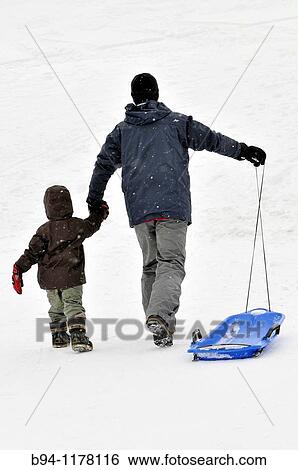 Man and boy with plastic sled. La Molina ski resort, Cerdanya, Girona province, Catalonia, Spain View Large Photo Image Stock Photograph - Man and boy with plastic sled. La Molina ski resort, Cerdanya, Girona province, Catalonia, Spain. Fotosearch