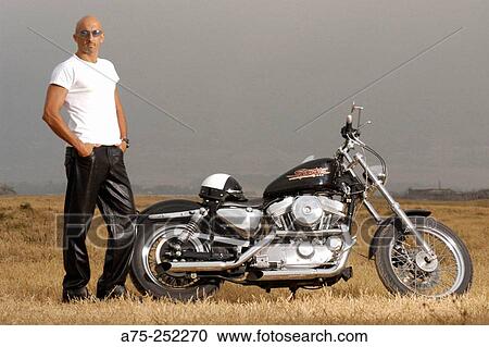 Stock Image - Man and Harley-Davidson Sportster. Fotosearch