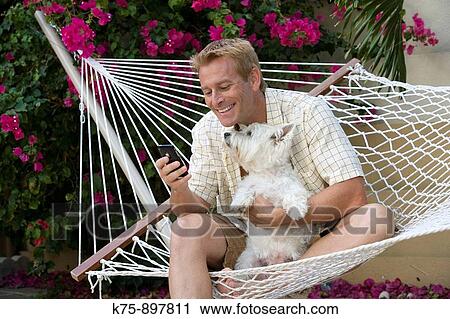 Man and his dog in hammock View Large Photo Image Stock Image - Man and his dog in hammock. Fotosearch