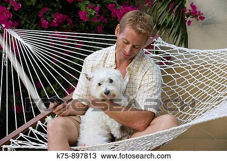 Man and his dog in hammock View Large Photo Image Stock Image - Man and his dog in hammock. Fotosearch