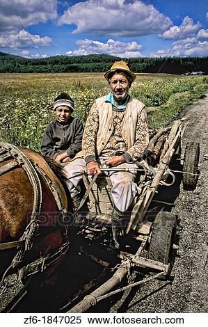 Stock Photography - Man and son on wagon with horse in rural Macedonia.. Fotosearch