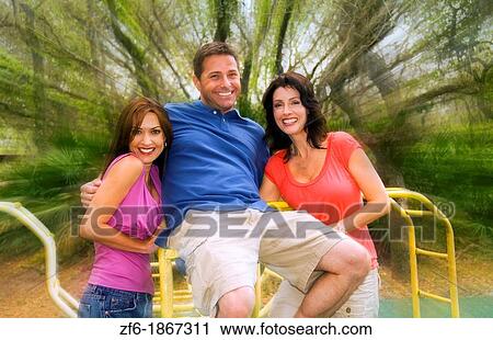 Man and two woman friends playing outdoors at playground View Large Photo Image Stock Image - Man and two woman friends playing outdoors at playground. Fotosearch