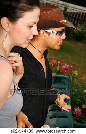 Stock Photo - Man and Woman at Backyard Party. Fotosearch