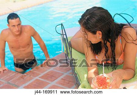 Man and woman by the pool View Large Photo Image Stock Image - Man and woman by the pool. Fotosearch