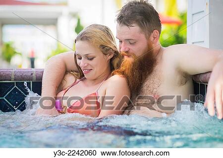 Man and woman in the 20s taking a bath in a hot tub wellness area. View Large Photo Image Stock Image - Man and woman in the 20s taking a bath in a hot tub wellness area.. Fotosearch