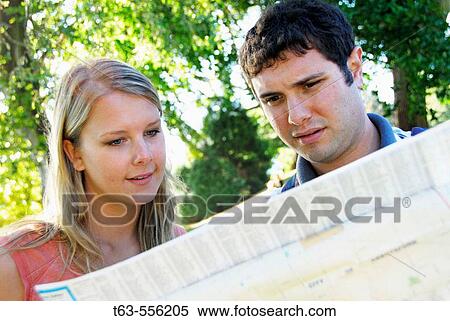 Stock Photography - man and woman looking at map. Fotosearch