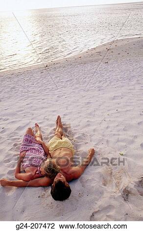 Man and woman lying together on beach. South Pacific View Large Photo Image Stock Image - Man and woman lying together on beach. South Pacific. Fotosearch