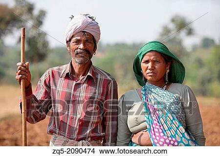 Picture - Man and Woman standing. Bhil tribe, Zabua district, Madhya Pradesh, India.. Fotosearch