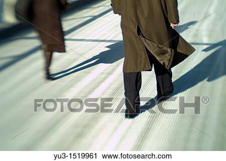 Man and woman walking separtely across the Millennium Bridge, London, England, Europe View Large Photo Image Stock Image - Man and woman walking separtely across the Millennium Bridge, London, England, Europe. Fotosearch