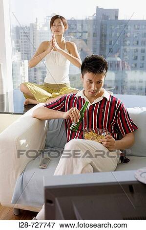 Man and woman watching TV together View Large Photo Image Stock Photo - Man and woman watching TV together. Fotosearch