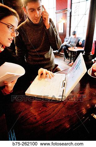 Man and woman with laptop in a pub. London. England View Large Photo Image Stock Image - Man and woman with laptop in a pub. London. England. Fotosearch