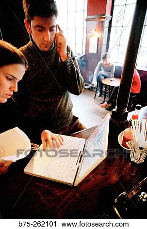 Man and woman with laptop in a pub. London. England View Large Photo Image Stock Image - Man and woman with laptop in a pub. London. England. Fotosearch