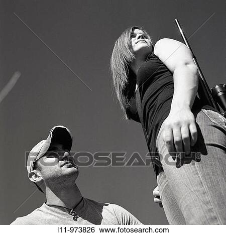 Man and woman with rifle, looking right. View Large Photo Image Stock Photograph - Man and woman with rifle, looking right.. Fotosearch