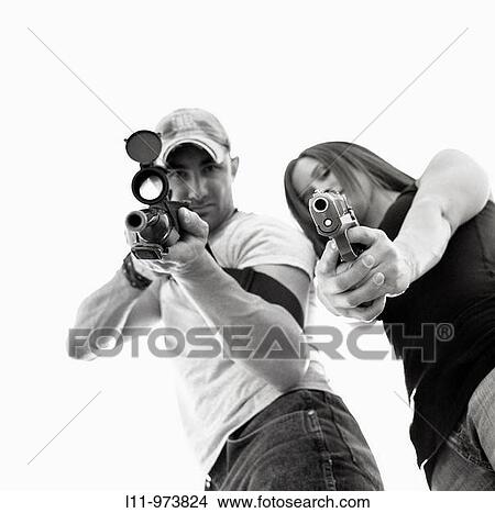 Man and women with guns; aiming at lens. View Large Photo Image Picture - Man and women with guns; aiming at lens.. Fotosearch