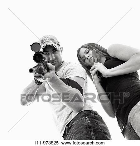 Man and women with guns; aiming at lens. View Large Photo Image Stock Photography - Man and women with guns; aiming at lens.. Fotosearch
