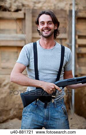 Stock Image - Man at shooting range. Fotosearch