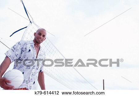 Man at the beach with volley ball. View Large Photo Image Stock Image - Man at the beach with volley ball.. Fotosearch