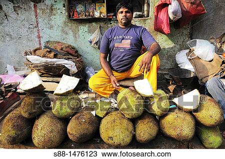 Man at the market selling Jack fruits, New Delhi, India View Large Photo Image Stock Image - Man at the market selling Jack fruits, New Delhi, India. Fotosearch