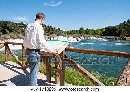 Man at the viewpoint. Laguna Lengua, Lagunas de Ruidera Nature Reserve, Ciudad Real province, Castilla La Mancha, Spain. View Large Photo Image Stock Photography - Man at the viewpoint. Laguna Lengua, Lagunas de Ruidera Nature Reserve, Ciudad Real province, Castilla La Mancha, Spain.. Fotosearch