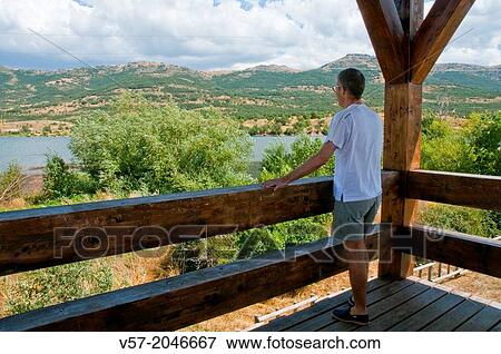 Man at the viewpoint. Pinilla reservoir, Pinilla del Valle, Madrid province, Spain. View Large Photo Image Stock Photo - Man at the viewpoint. Pinilla reservoir, Pinilla del Valle, Madrid province, Spain.. Fotosearch