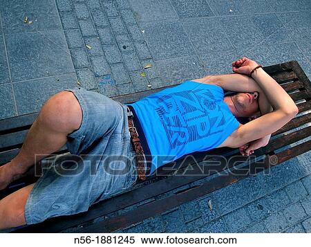 Stock Photography - Man awakening on a bench. Fotosearch