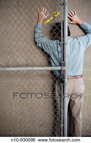 Man Behind A Chain Link Fence Door Stock Photograph N10 930096