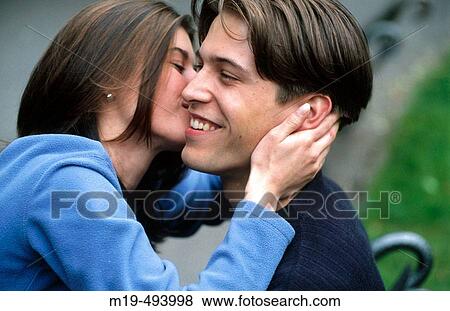 man being kissed by a girl View Large Photo Image Stock Photo - man being kissed by a girl. Fotosearch