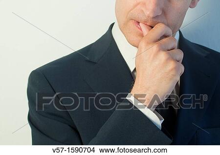 Man biting his nails. Close view. View Large Photo Image Picture - Man biting his nails. Close view.. Fotosearch