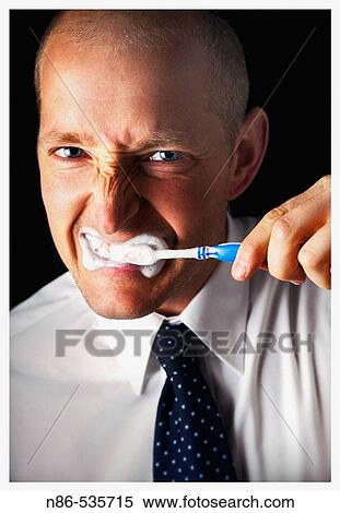 Stock Photography - Man brushing teeth. Fotosearch