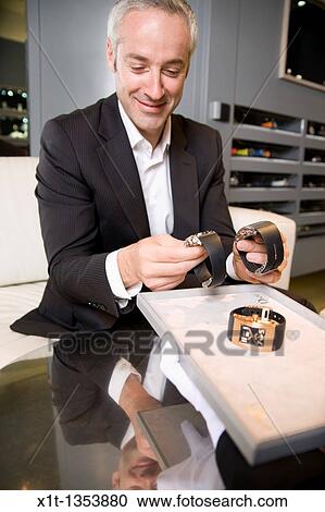 Stock Image - Man buying a wristwatch. Fotosearch
