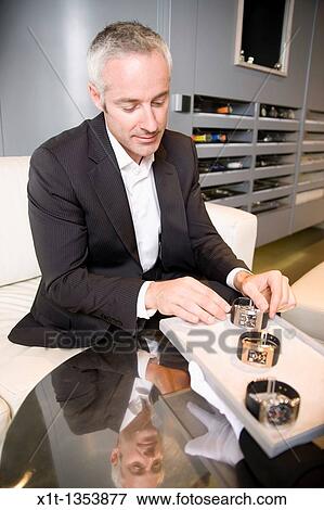 Stock Photo - Man buying a wristwatch. Fotosearch