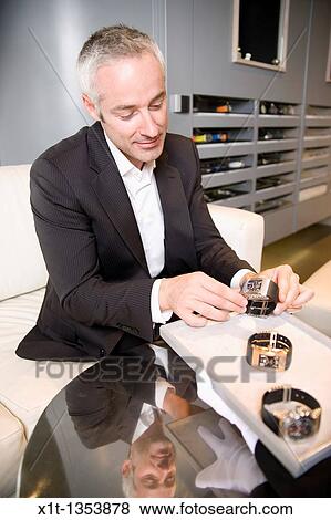 Stock Photo - Man buying a wristwatch. Fotosearch