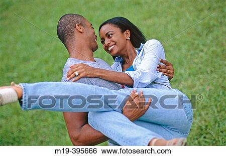 man carrying his girlfriend in his arms View Large Photo Image Stock Photograph - man carrying his girlfriend in his arms. Fotosearch