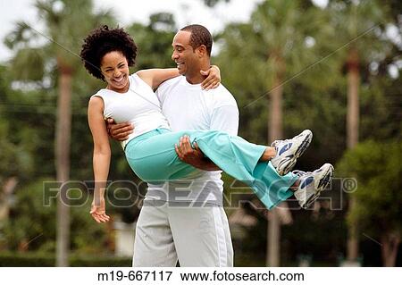 Man carrying his girlfriend View Large Photo Image Stock Photo - Man carrying his girlfriend. Fotosearch