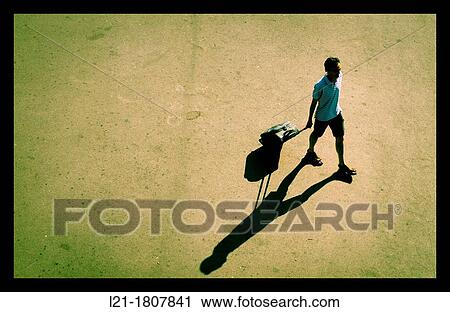 Man carrying his suitcase on wheels behind him. View from above. View Large Photo Image Stock Image - Man carrying his suitcase on wheels behind him. View from above.. Fotosearch