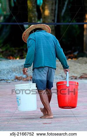 Man carrying pails, Sarawak, Borneo, Malaysia View Large Photo Image Stock Image - Man carrying pails, Sarawak, Borneo, Malaysia. Fotosearch