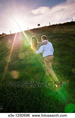 Man carrying woman uphill at sunset View Large Photo Image Stock Photograph - Man carrying woman uphill at sunset. Fotosearch