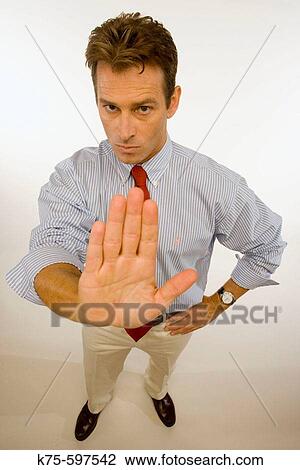 Stock Image - man, caucasian, hand gesture, stop. Fotosearch