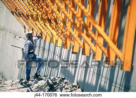 Man checking metal beams in a construction View Large Photo Image Stock Photograph - Man checking metal beams in a construction. Fotosearch
