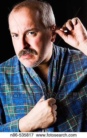 Man cleaning ears View Large Photo Image Stock Photo - Man cleaning ears. Fotosearch