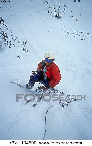 Stock Image - Man, climbing during a strom high in the North Couloir on The North Face of Cobb Peak, Pioneer Mountains, Idaho. Fotosearch