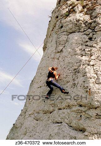 Man climbing on rock View Large Photo Image Stock Image - Man climbing on rock. Fotosearch